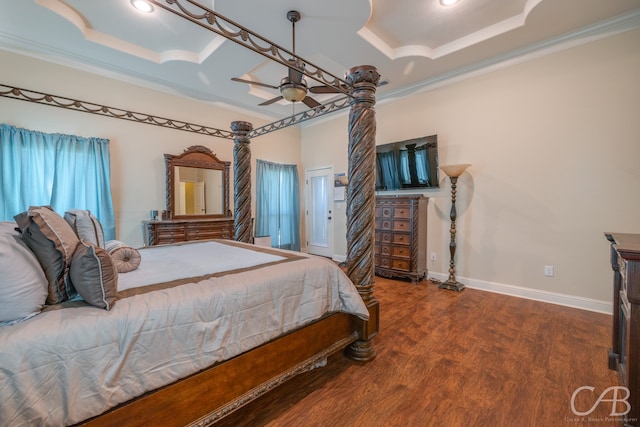 bedroom featuring dark hardwood / wood-style flooring, a raised ceiling, ceiling fan, and ornamental molding