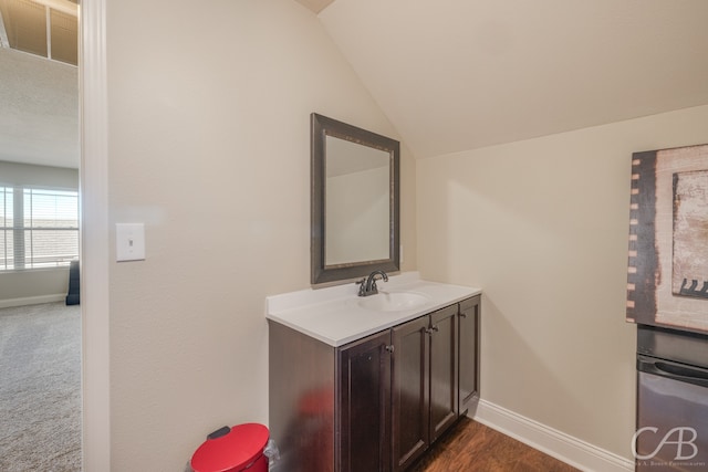 bathroom featuring vanity and vaulted ceiling