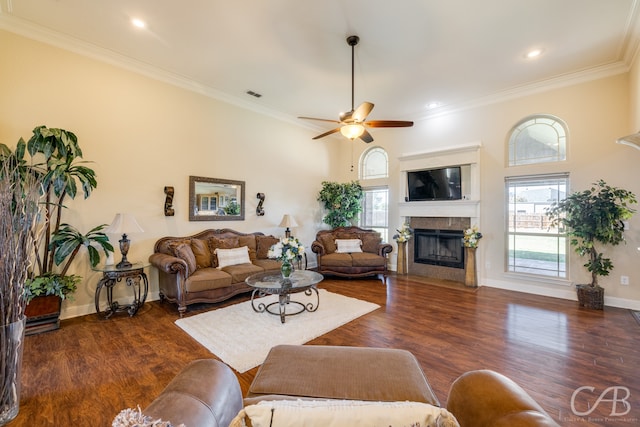 living room featuring dark hardwood / wood-style floors, ceiling fan, and ornamental molding