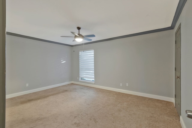 spare room with light carpet, ceiling fan, and crown molding