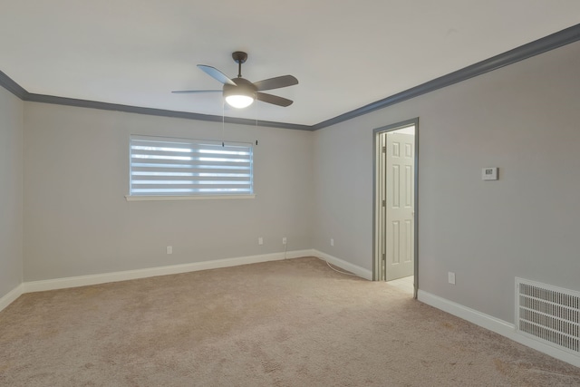 carpeted empty room with ceiling fan and ornamental molding