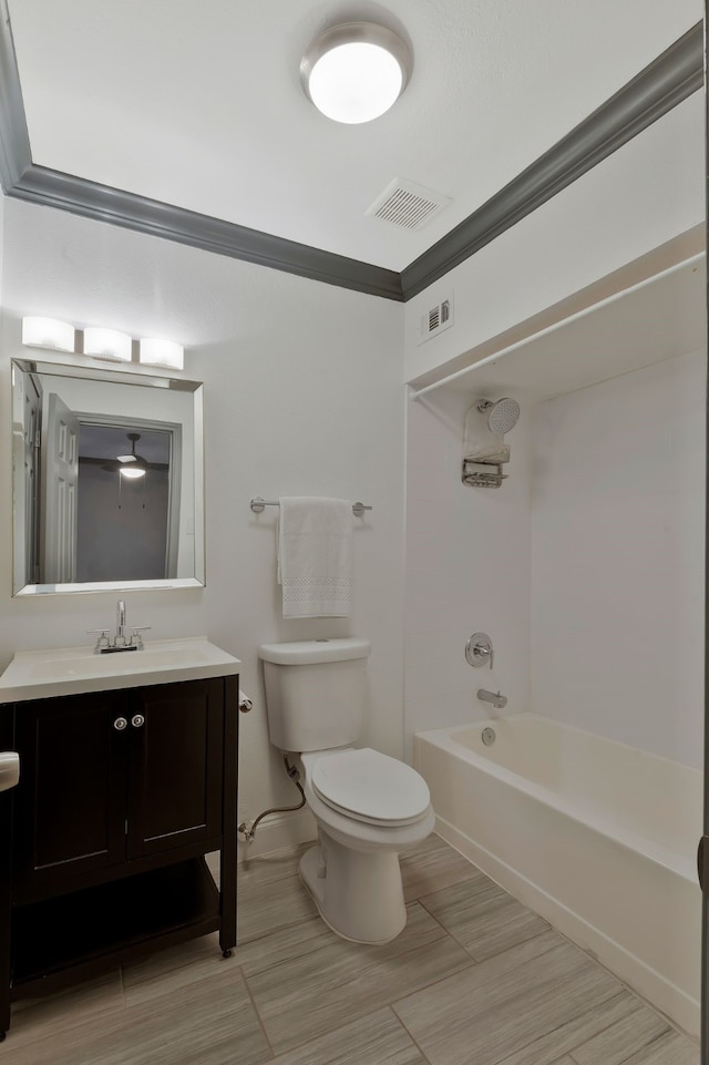 full bathroom featuring vanity, toilet, ornamental molding, and bathing tub / shower combination