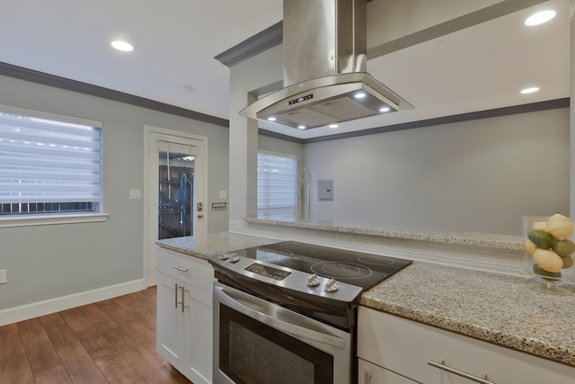 kitchen featuring stainless steel range with electric stovetop, crown molding, light stone countertops, island range hood, and dark hardwood / wood-style flooring