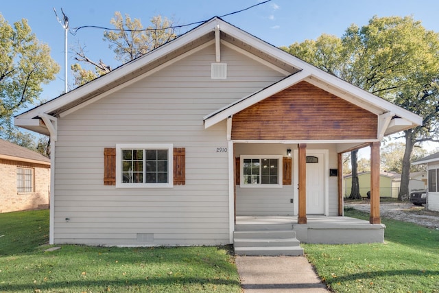 bungalow featuring a front lawn and a porch