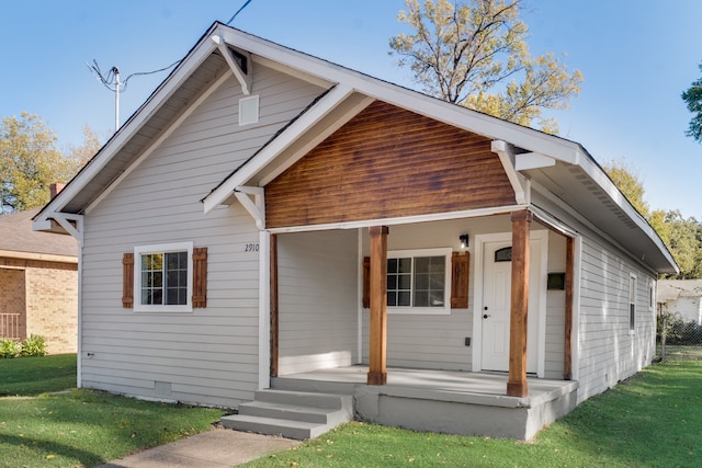 bungalow-style house with a front lawn and a porch