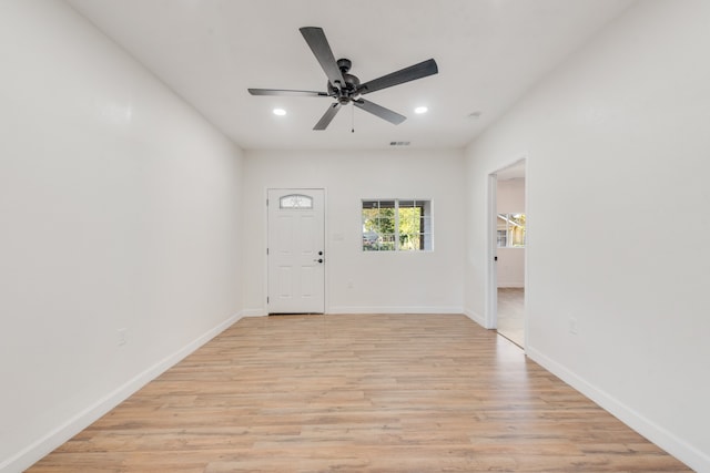 foyer with ceiling fan and light wood-type flooring