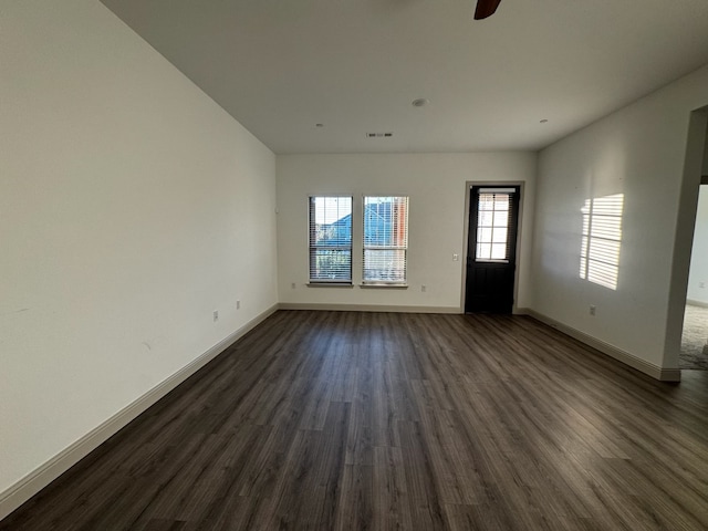 unfurnished living room featuring ceiling fan and dark hardwood / wood-style flooring