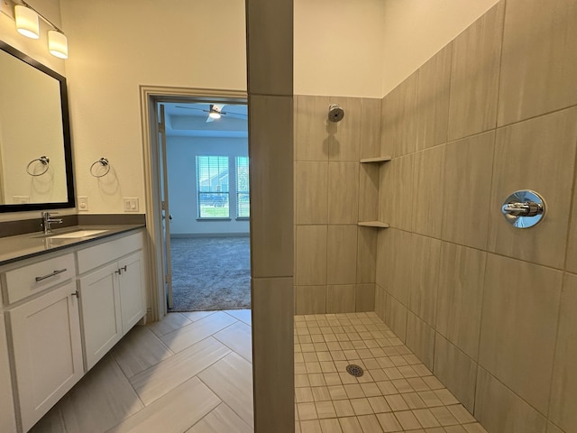 bathroom featuring tile patterned floors, vanity, and tiled shower