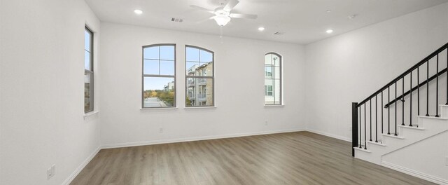 walk in closet featuring light carpet and ceiling fan