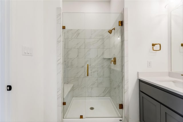 bathroom with vanity and a shower with shower door