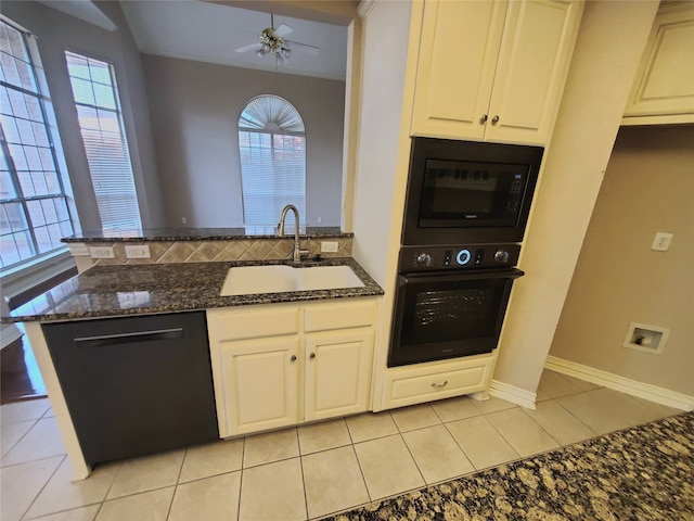 kitchen featuring black appliances, white cabinetry, sink, and dark stone counters