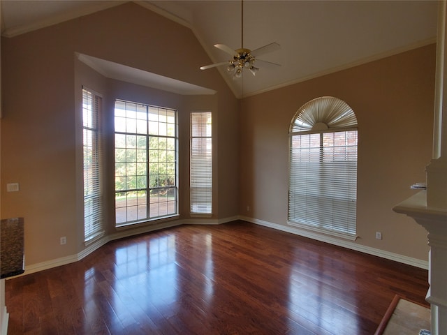 unfurnished dining area featuring ceiling fan, lofted ceiling, dark wood-type flooring, and ornamental molding