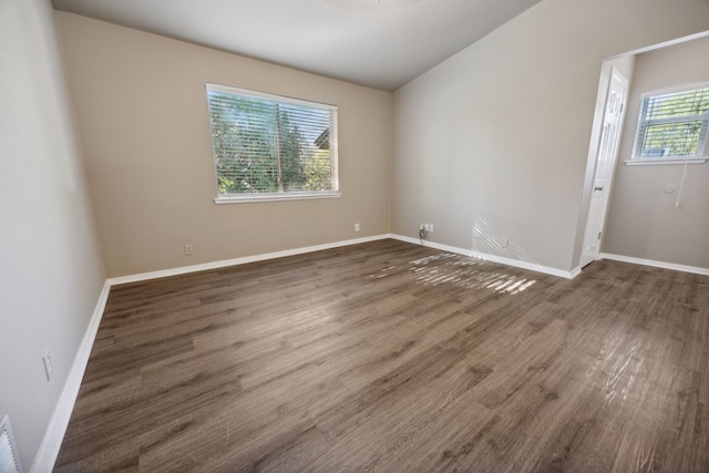 empty room with dark wood-type flooring