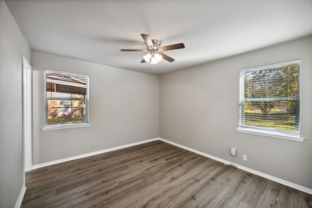 spare room featuring ceiling fan and dark wood-type flooring