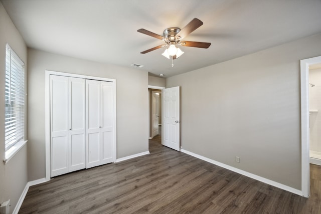 unfurnished bedroom featuring a closet, ceiling fan, and dark hardwood / wood-style flooring