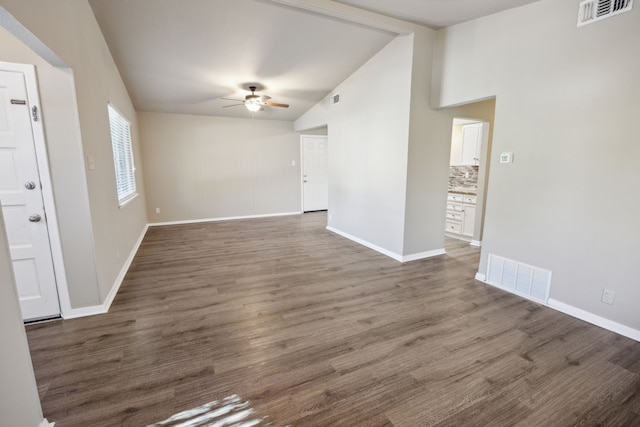 unfurnished living room featuring ceiling fan, dark wood-type flooring, and lofted ceiling