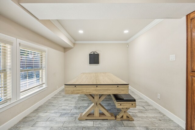 dining room with light hardwood / wood-style flooring and ornamental molding