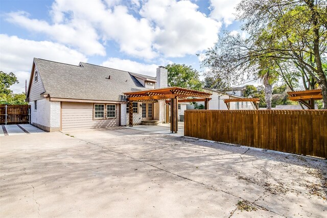 rear view of house with a pergola and a patio area