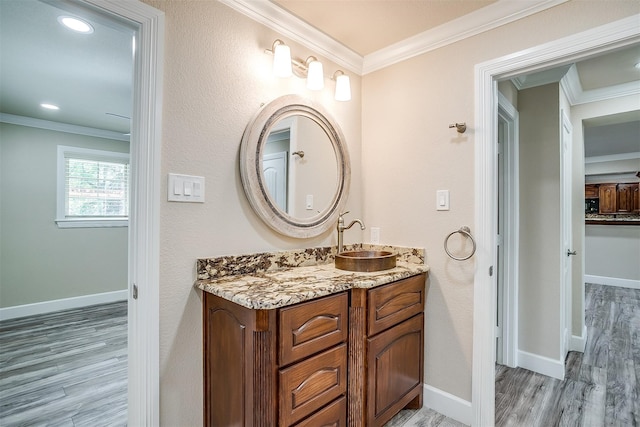 bathroom featuring hardwood / wood-style flooring, vanity, and crown molding