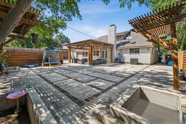 exterior space featuring a pergola, a trampoline, and central AC