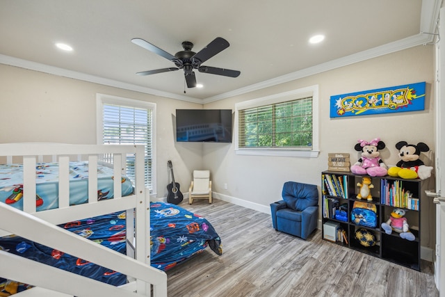 bedroom featuring ceiling fan, hardwood / wood-style floors, and crown molding