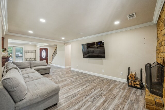 living room featuring crown molding and light hardwood / wood-style flooring