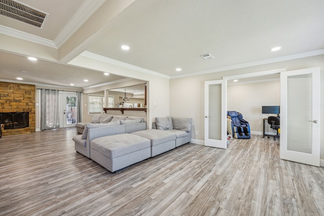 living room featuring light hardwood / wood-style floors, crown molding, and french doors