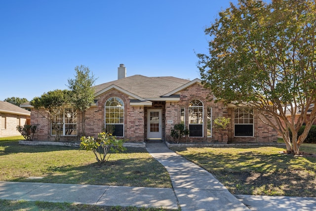 1306 Woodmont Dr, Allen, TX 75002 - view of front facade with a front lawn, brick siding, and a chimney