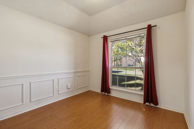 1306 Woodmont Dr, Allen, TX 75002 - spare room featuring wood finished floors and a textured ceiling