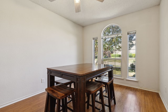 1306 Woodmont Dr, Allen, TX 75002 - dining room with baseboards, wood finished floors, ceiling fan, and a textured ceiling