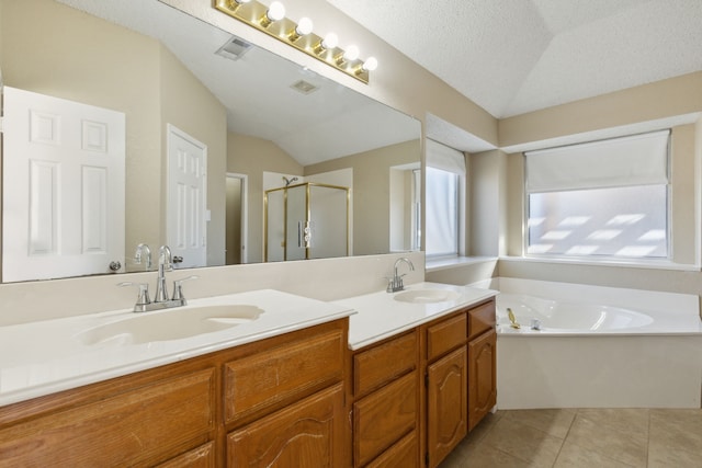 1306 Woodmont Dr, Allen, TX 75002 - bathroom with double vanity, a stall shower, vaulted ceiling, tile patterned floors, and a bath