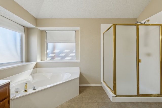 1306 Woodmont Dr, Allen, TX 75002 - bathroom with a textured ceiling, a stall shower, a garden tub, vanity, and tile patterned floors