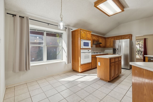 1306 Woodmont Dr, Allen, TX 75002 - kitchen featuring white appliances, light countertops, under cabinet range hood, plenty of natural light, and vaulted ceiling