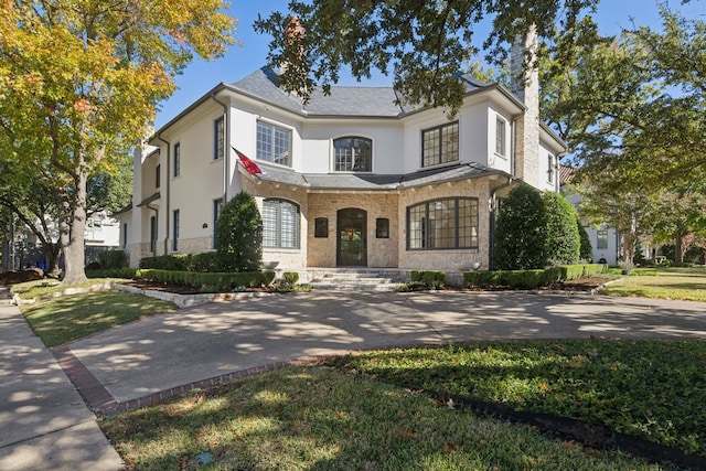 3648 Mcfarlin Blvd, University Park, TX 75205 - french country home featuring stucco siding, a chimney, and stone siding