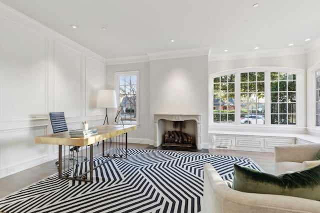 office area with wood-type flooring and ornamental molding