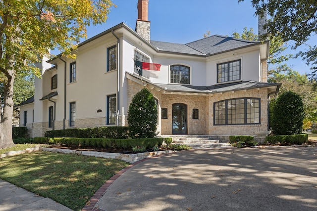 3648 Mcfarlin Blvd, University Park, TX 75205 - french country home with a chimney, stone siding, and stucco siding