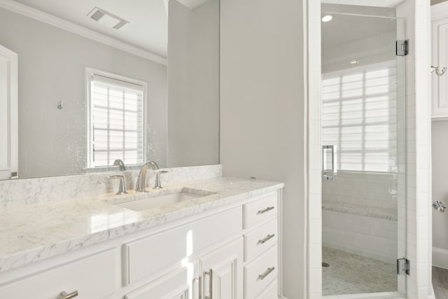 bathroom featuring crown molding, vanity, and walk in shower