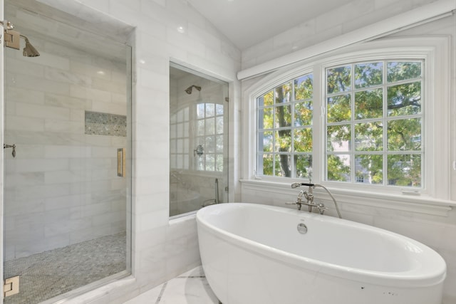 bathroom featuring vaulted ceiling and shower with separate bathtub