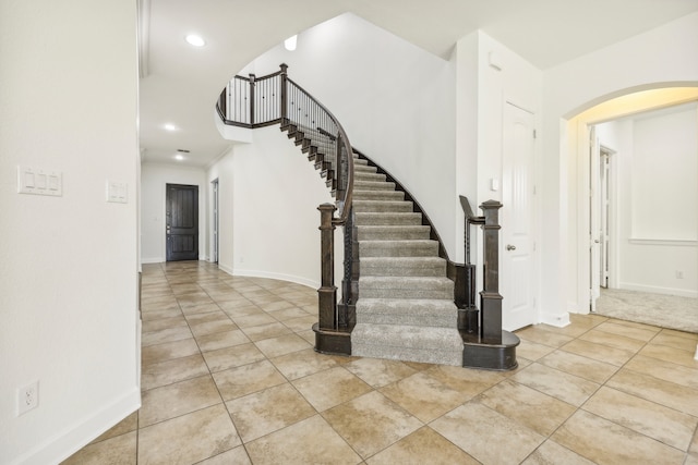 staircase with tile patterned floors