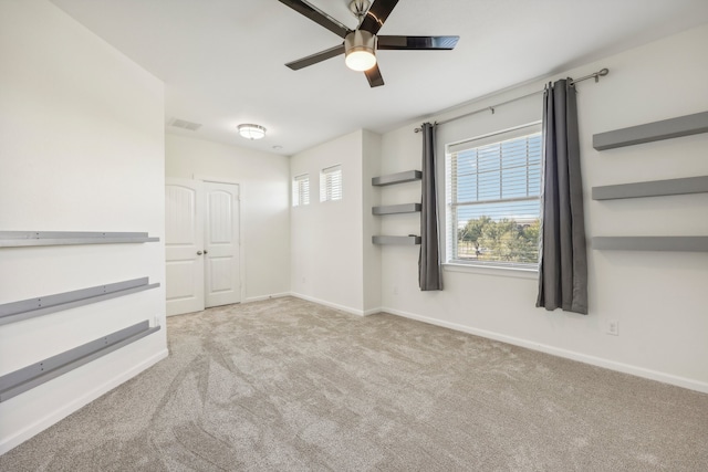 empty room with ceiling fan and light colored carpet