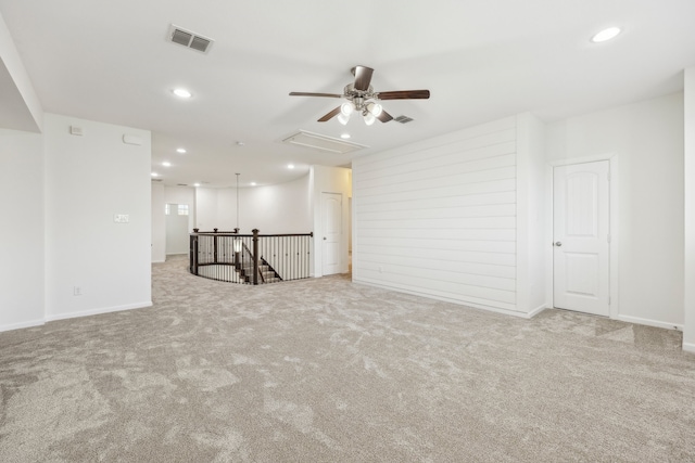 unfurnished room featuring ceiling fan and light colored carpet