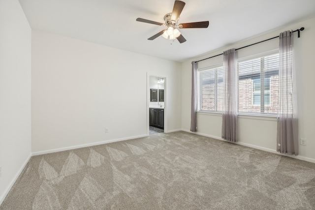 carpeted spare room featuring ceiling fan