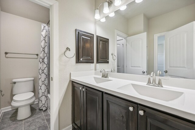 full bathroom featuring tile patterned flooring, vanity, toilet, and shower / bathtub combination with curtain