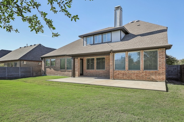 back of property featuring a patio area and a yard