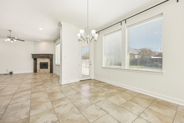 unfurnished living room with ceiling fan with notable chandelier, light tile patterned floors, and a fireplace