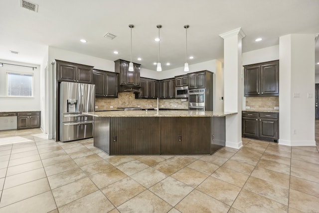 kitchen with dark brown cabinets, light stone countertops, backsplash, and appliances with stainless steel finishes