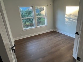 spare room with dark hardwood / wood-style flooring