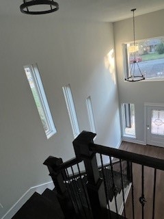 stairway featuring an inviting chandelier