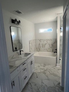 bathroom with a bathtub and vanity