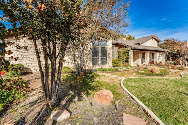 view of side of property featuring a yard